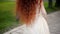 Girl with natural red curly hair.A natural beauty. A little wind ruffles your hair