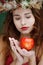 Girl in natural wreath with apple