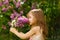 Girl near lilac flowers snuff bouquet