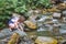 Girl near the mountain river. Journey through the mountainous terrain_