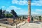 A girl near a Roman column in Carthage. Tourists at the Museum excavations of the ancient city in Tunisia