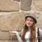 Girl near a wall painted chalk heart and arrow.