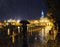 Girl at the night city lights during the rain at the evening to