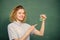 Girl observing chemical reaction chalkboard background. Chemistry lesson. Chemistry lab. Woman teacher performing