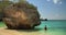 Girl in ocean near huge stone, Bali, Indonesia, 4k