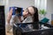 A girl in the office is looking at a new computer part in a box.