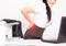 Girl office worker holding her aching back from a chair, the concept of back pain in office workers, lactic acid in muscles and