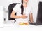 Girl office worker near which lies a sandwich holding on to a stomach in which there is pain and inflammation in the stomach.