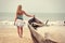 Girl at the old fishing boat looking to the ocean