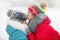 Girl, older sister calms younger who cried after falling in the snow on a walk in the park