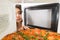 Girl open a microwave