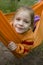 Girl in orange hammock in forest
