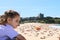 Girl overlooking crowded summer beach