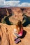 Girl overlooking Horse Shoe Bend landscape, Arizona, United States