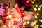 Girl packing christmas present sitting at the wooden table