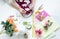 The girl is packing products from handmade artificial flowers.The workplace of a florist designer for the production of faux