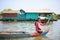 Girl paddle from front part of a boat