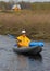 Girl with paddles a kayak and a house in the backg