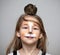 Girl painted as a cat with grey mouse on the head