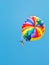 Girl parakiting on parachute in blue sky