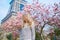 Girl in Paris near the Eiffel tower and pink magnolia