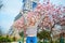 Girl in Paris near the Eiffel tower and pink magnolia