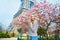 Girl in Paris near the Eiffel tower and pink magnolia