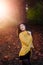 Girl in a park with autumn leaves around her.