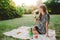 Girl in park looking at bottle of champagne