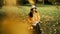 A girl in the park sits on a wooden chair and reads a book