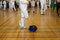 Girl participant in the fencing competition on swords is in the center of gym