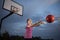 Girl passing a basketball at an outdoor court