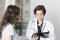 Girl patient and doctor in examination room.