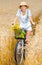 Girl pedals cycle with apples and flowers