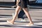 Girl pedestrian walking on a crosswalk