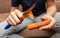 Girl peeling boiled carrots with a knife