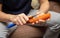 Girl peeling boiled carrots with a knife