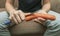 Girl peeling boiled carrots with a knife