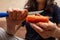 Girl peeling boiled carrots with a knife