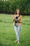 Girl with pen writing on notebook on grass outside