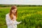 girl with pen writing on notebook on grass outside