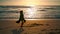 Girl performing sensual dance on sand beach at sunrise. Silhouette woman dancer.