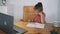 A girl performs a task in an online lesson. The child communicates online while sitting at the table. child is studying at home