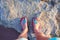 Girl photographed their feet on the shore of Lake Las Salinas. Torrevieja, Spain.