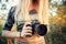 Girl photographer holds Nikon D610 camera and Nikkor 50mm f/1.4G lens