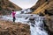 Girl photographing a waterfall on the phone