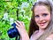 Girl photographs blossoming tree