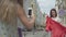 Girl photographs on cell phone happy adorable fun fashionista girlfriend outdoors. Happy girl shows off her new red