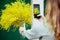 Girl photographs her bouquet on the phone, image, technology, holiday