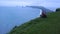 Girl photographs puffins in Dyrholaey, Iceland